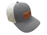 Richardson hat with brown front and khaki back. With custom leather laser engraved patch sewn onto the front